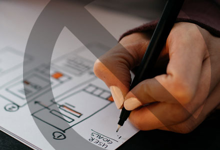 A hand illustrating on paper with a no symbol over the top.