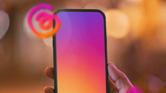 A hand holding a mobile phone with the threads logo.