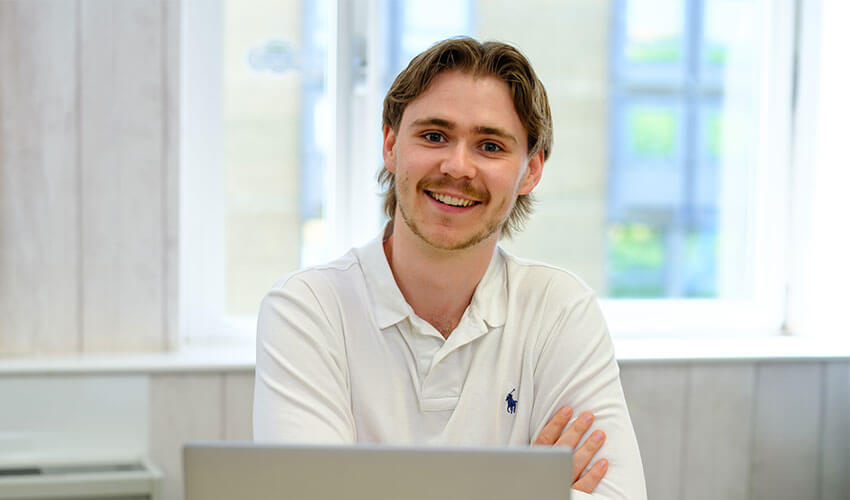Chris working on a laptop.