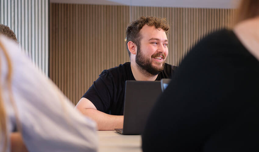 Dan and the digital team chatting while working.