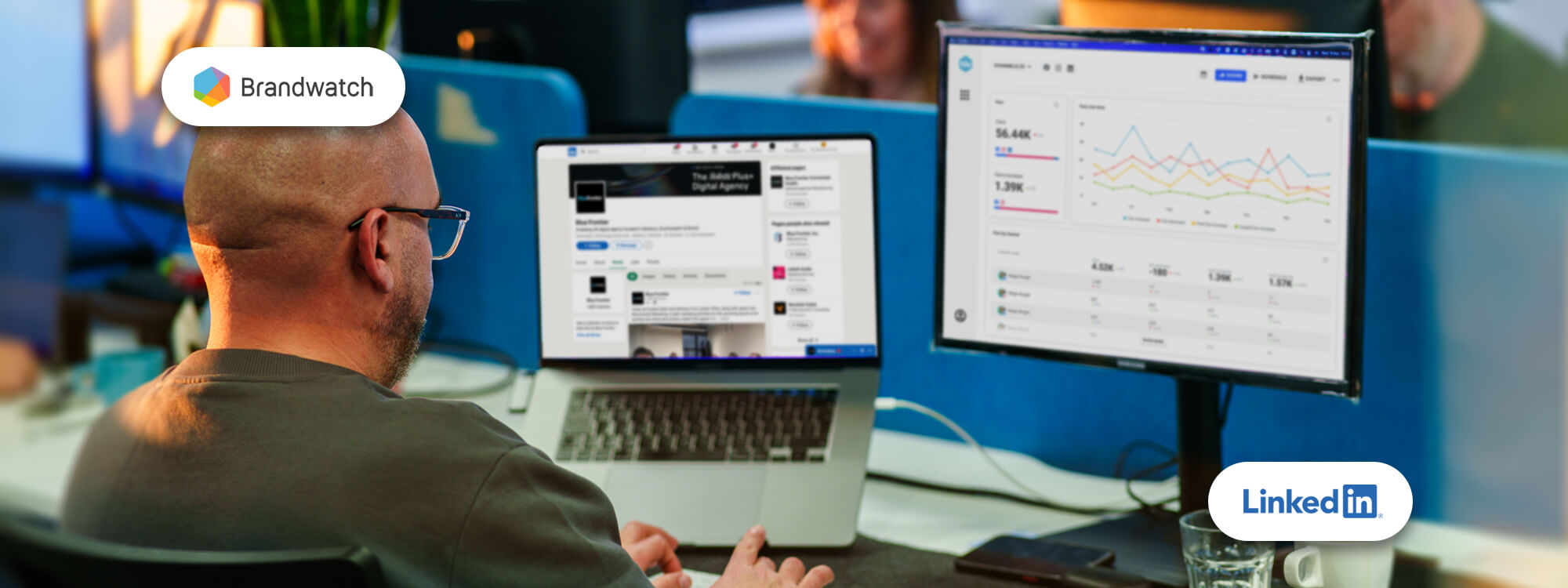 a man uses LinkedIn and Brandwatch on his laptop in a bright office space