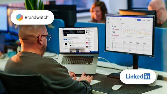 a man uses LinkedIn and Brandwatch on his laptop in a bright office space