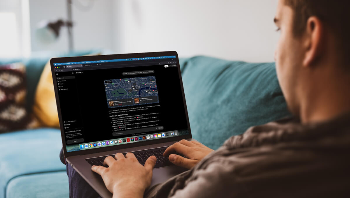a man uses ChatGPT on his laptop to help him find restaurant suggestions in London