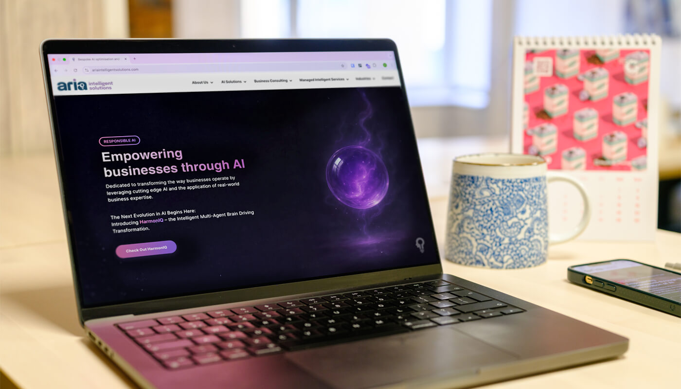 a laptop on a desktop featuring the Aria Intelligent Solutions website home page