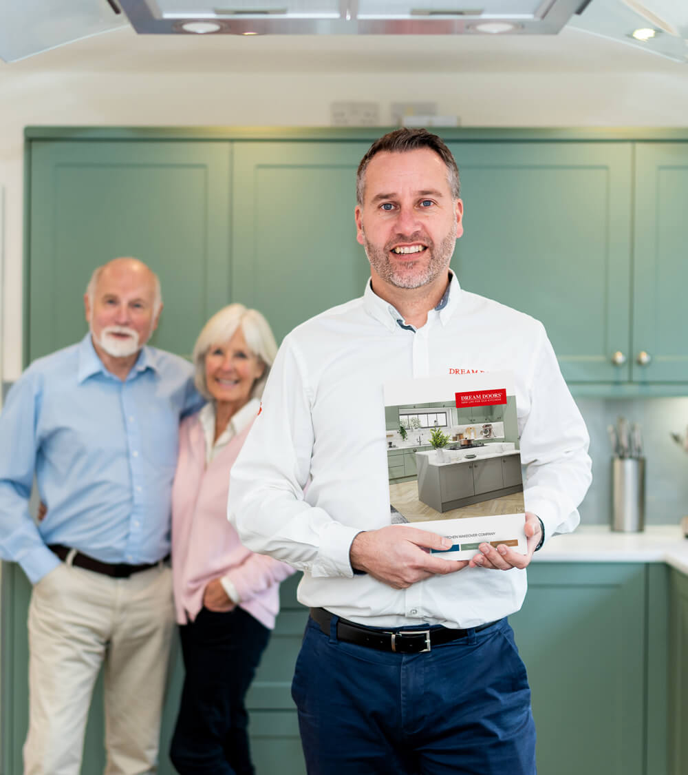 a proud franchise owner smiling at the camera and holding a bright red brochure