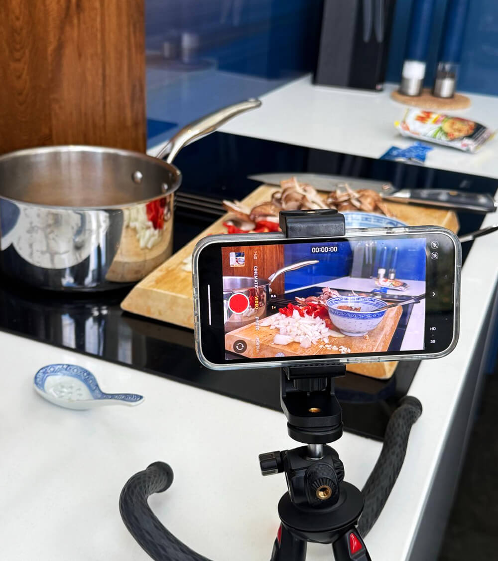 a phone on a tripod filming the MAMA Noodles social media cooking videos