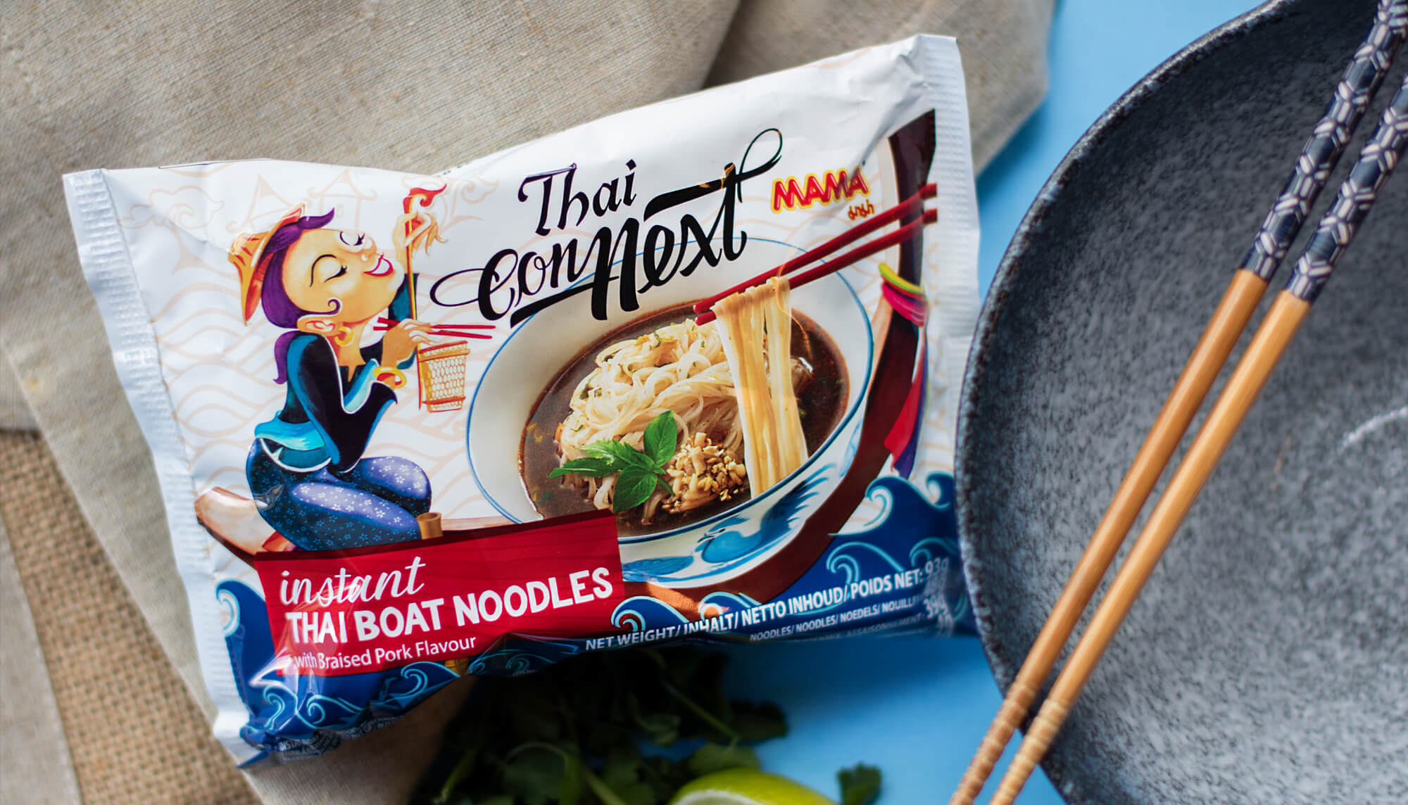 a packet of MAMA Noodles' Thai boat noodles next to a bowl and some chopsticks