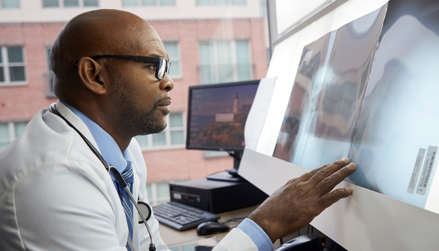 Medical person looking at computer