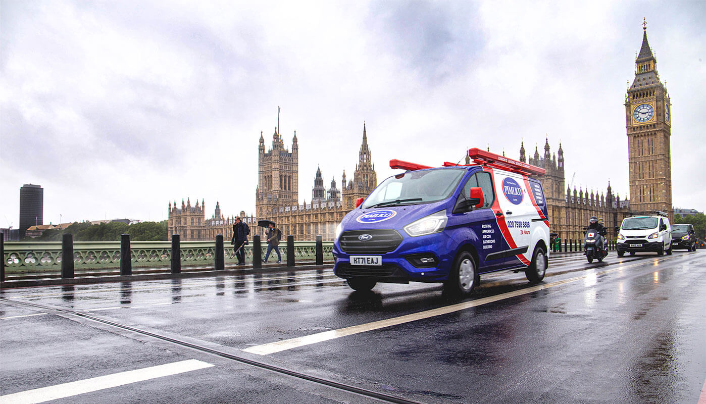 a branded Pimlico Plumbers van driving across Westminster bridge with Big Ben in the background