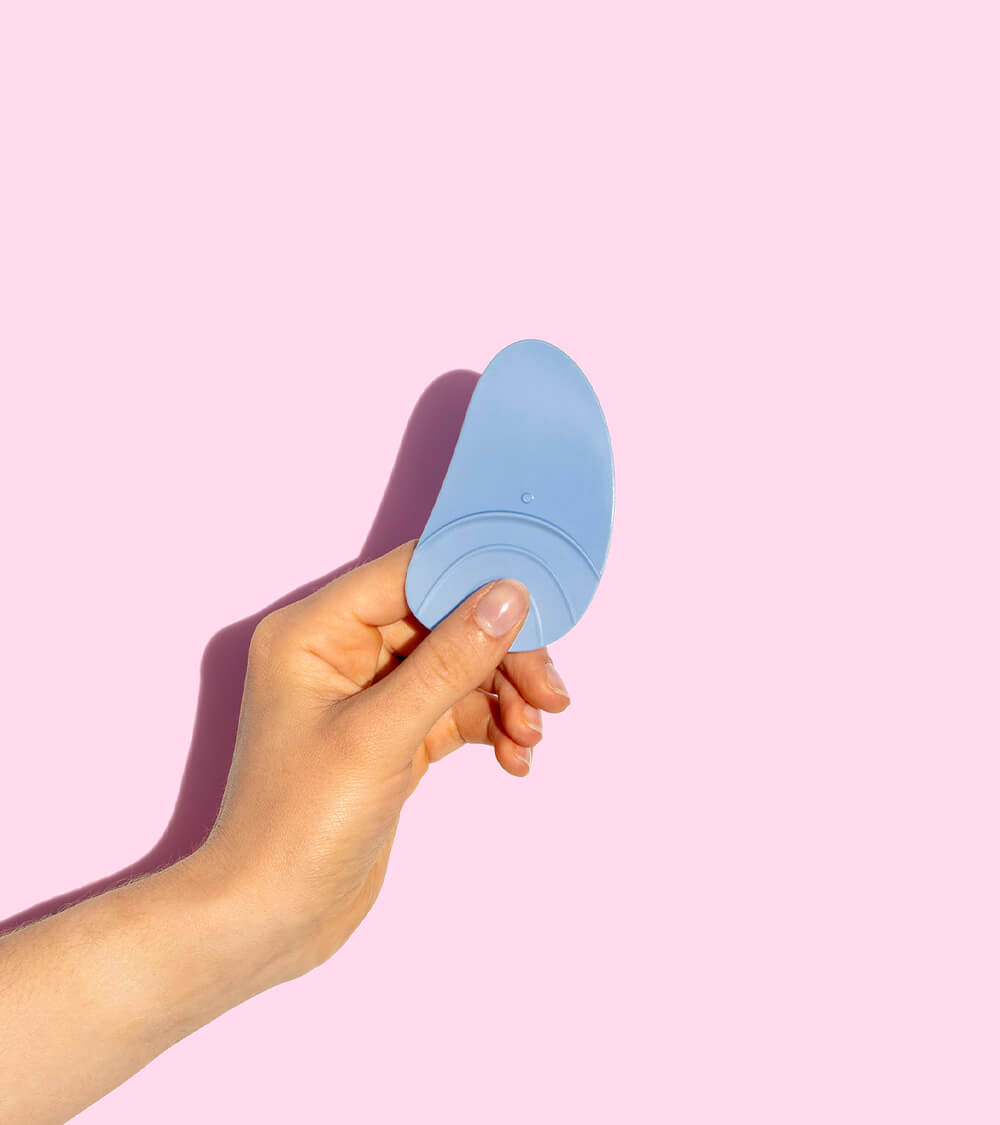 A hand holding a reusable wiper.