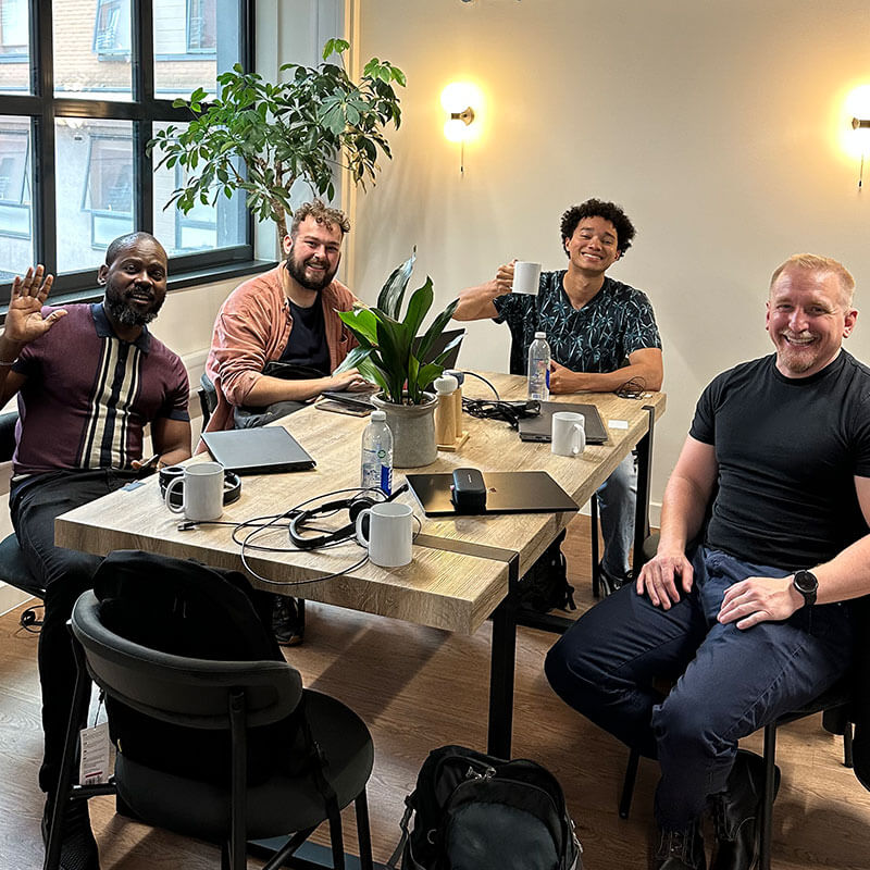 London team working at a table.
