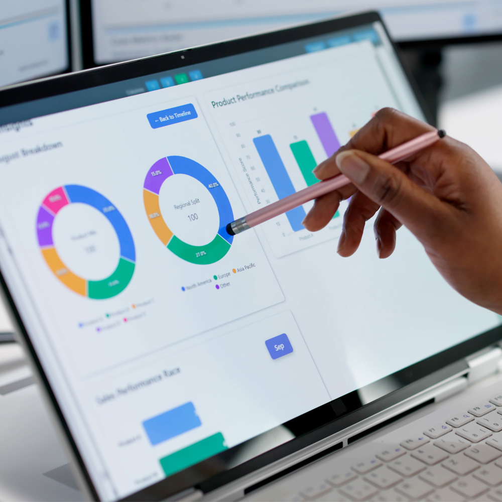 a person pointing to a vibrant multi-coloured pie graph on a laptop screen