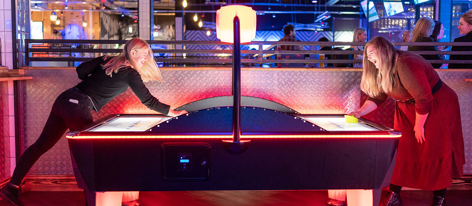 The team playing air hockey.
