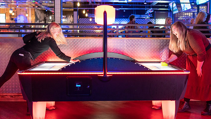 The team playing air hockey.
