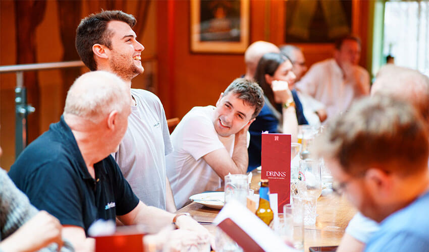 Staff laughing together at the conference meal.