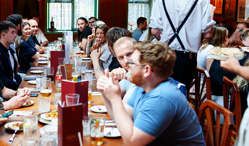 Staff at the conference meal talking.