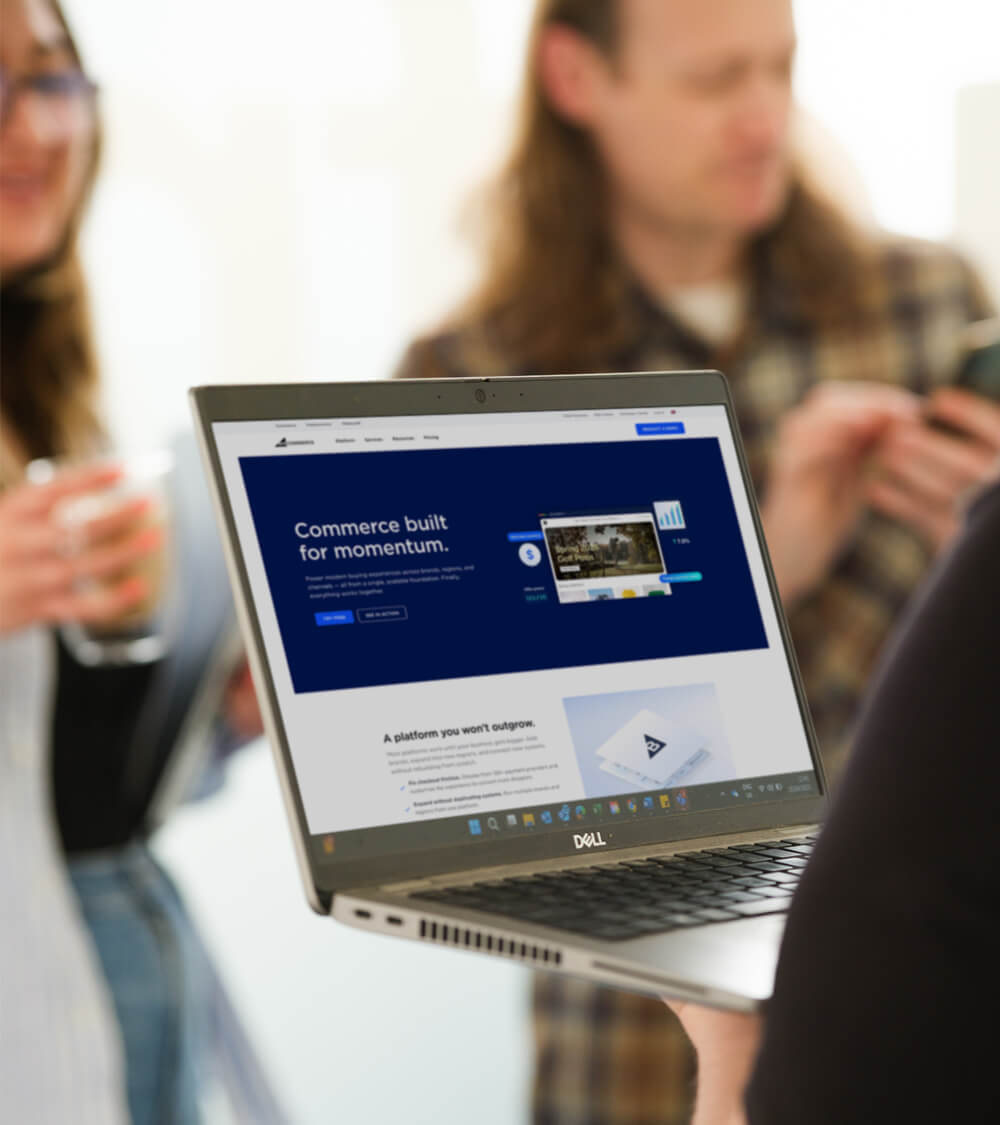 a laptop with the BigCommerce brochure website on screen