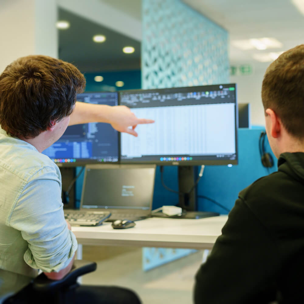 two team members discussing next steps against a project timeline