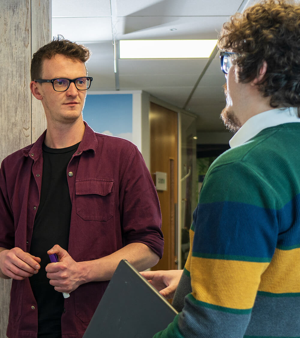 David and Sam talking in Bristol office