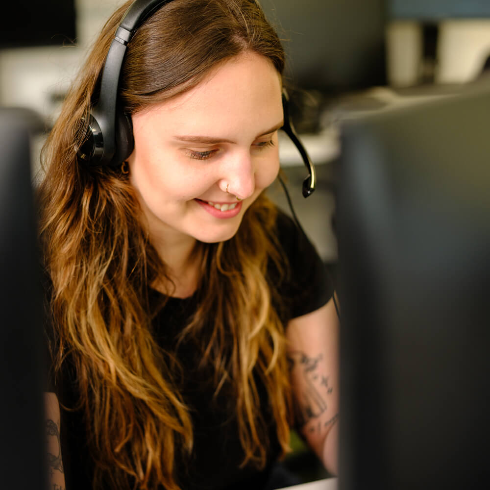 a paid ads specialist wearing a headset speaking to a client