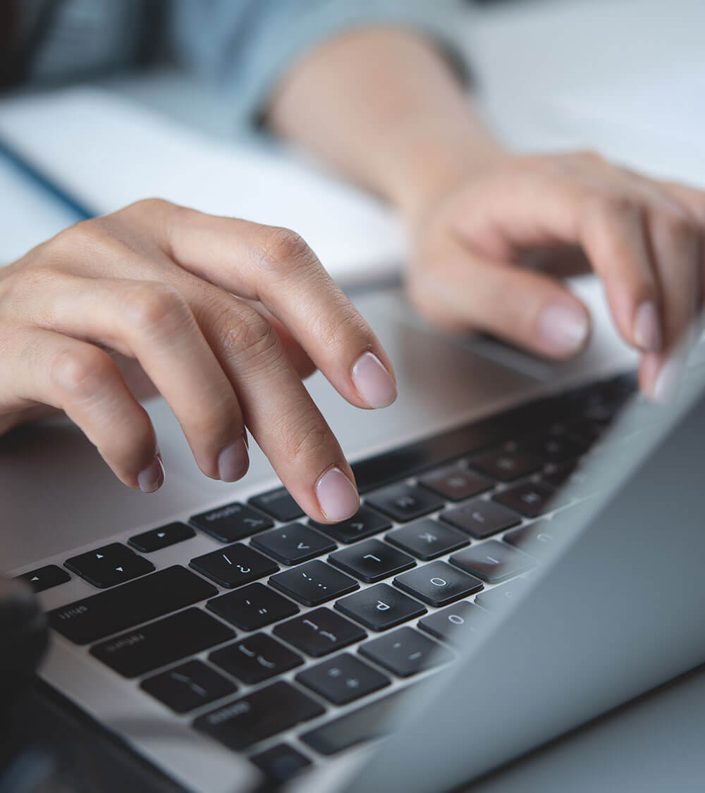 person typing on laptop computer