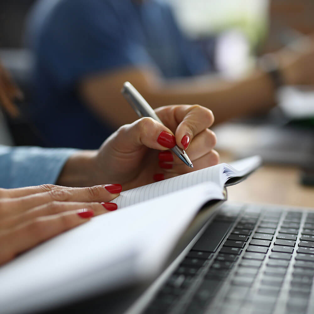 Research - person with Pen and Paper