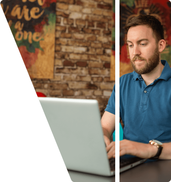 Adam working on a laptop.