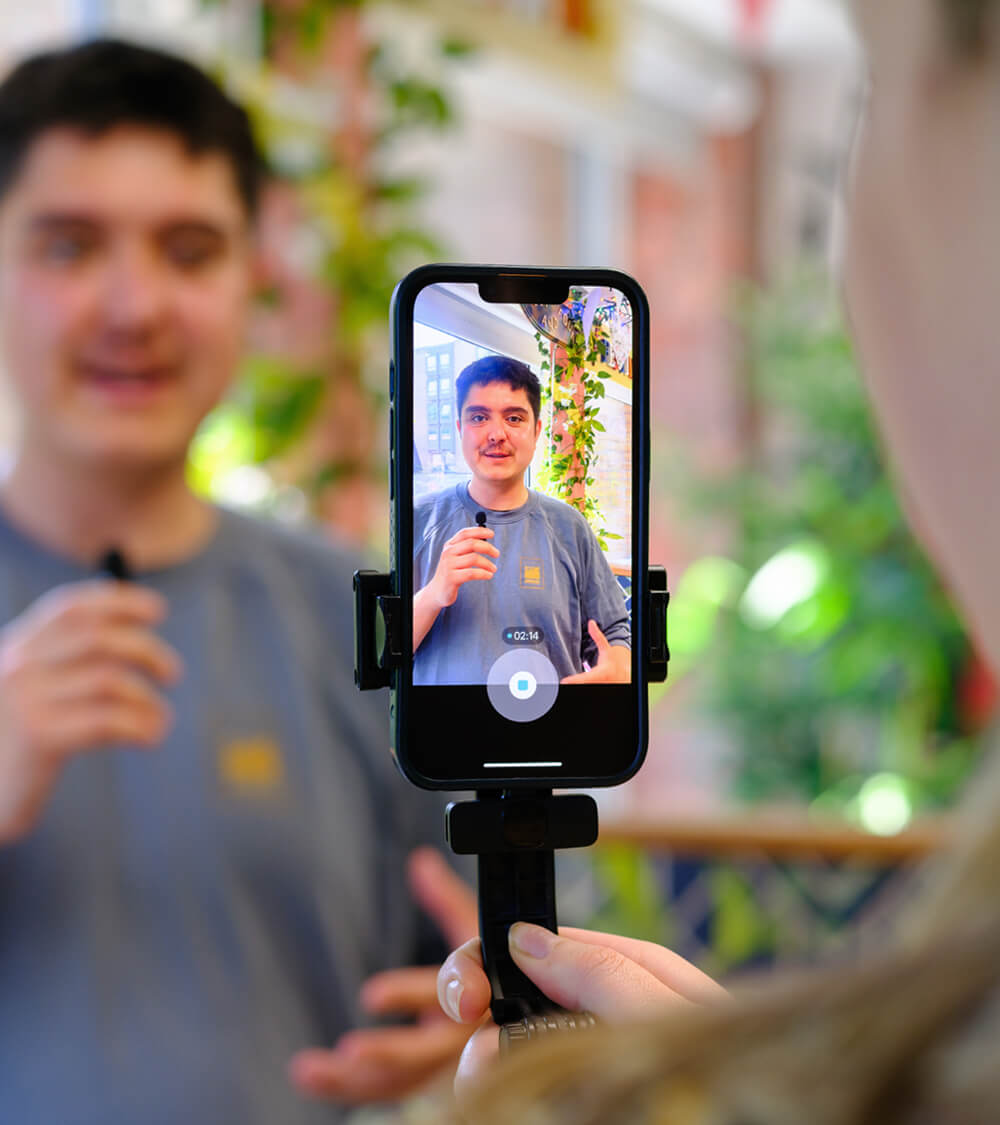 a phone recording a person for a live social media feed