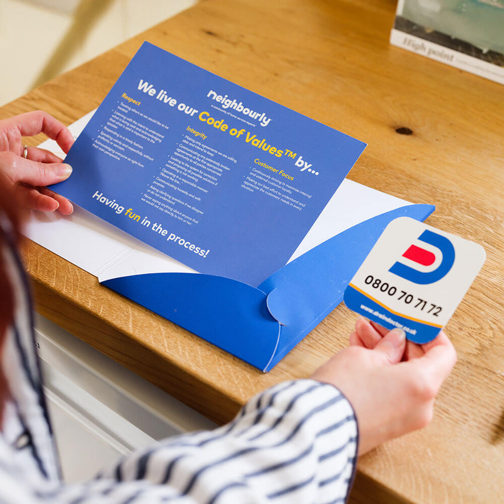 a customer reading a bright blue Drain Doctor brochure