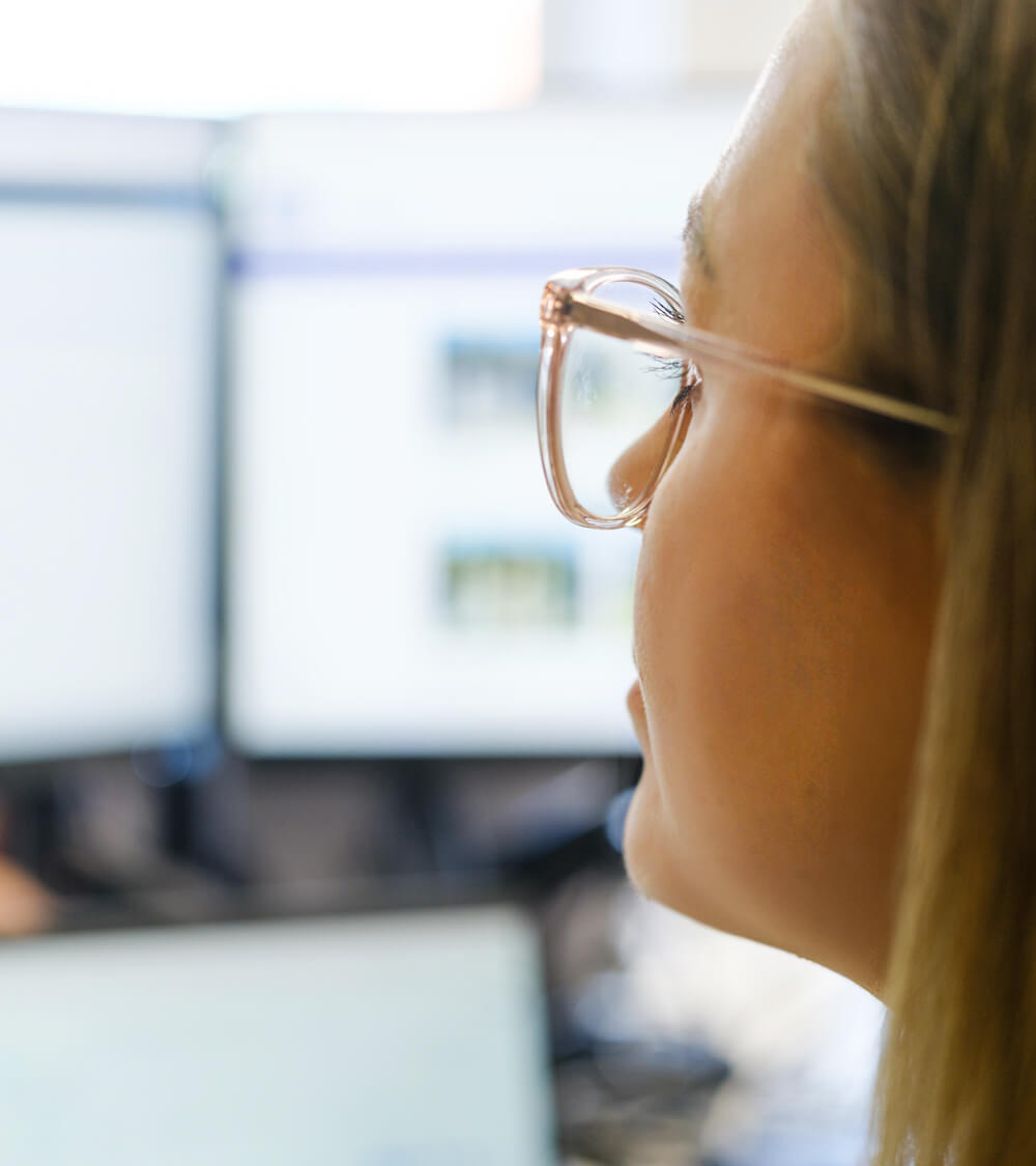 a woman using ChatGPT to run a search on her computer