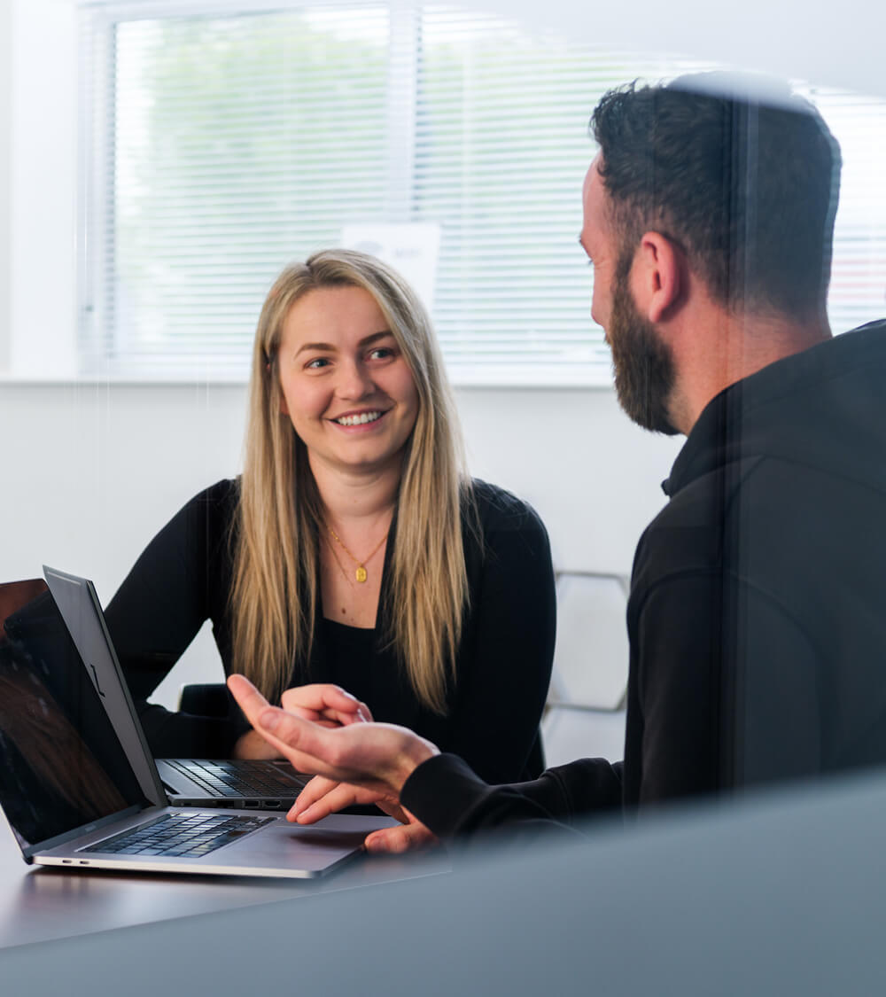 a consultant speaks with a customer in a bright and modern meeting room