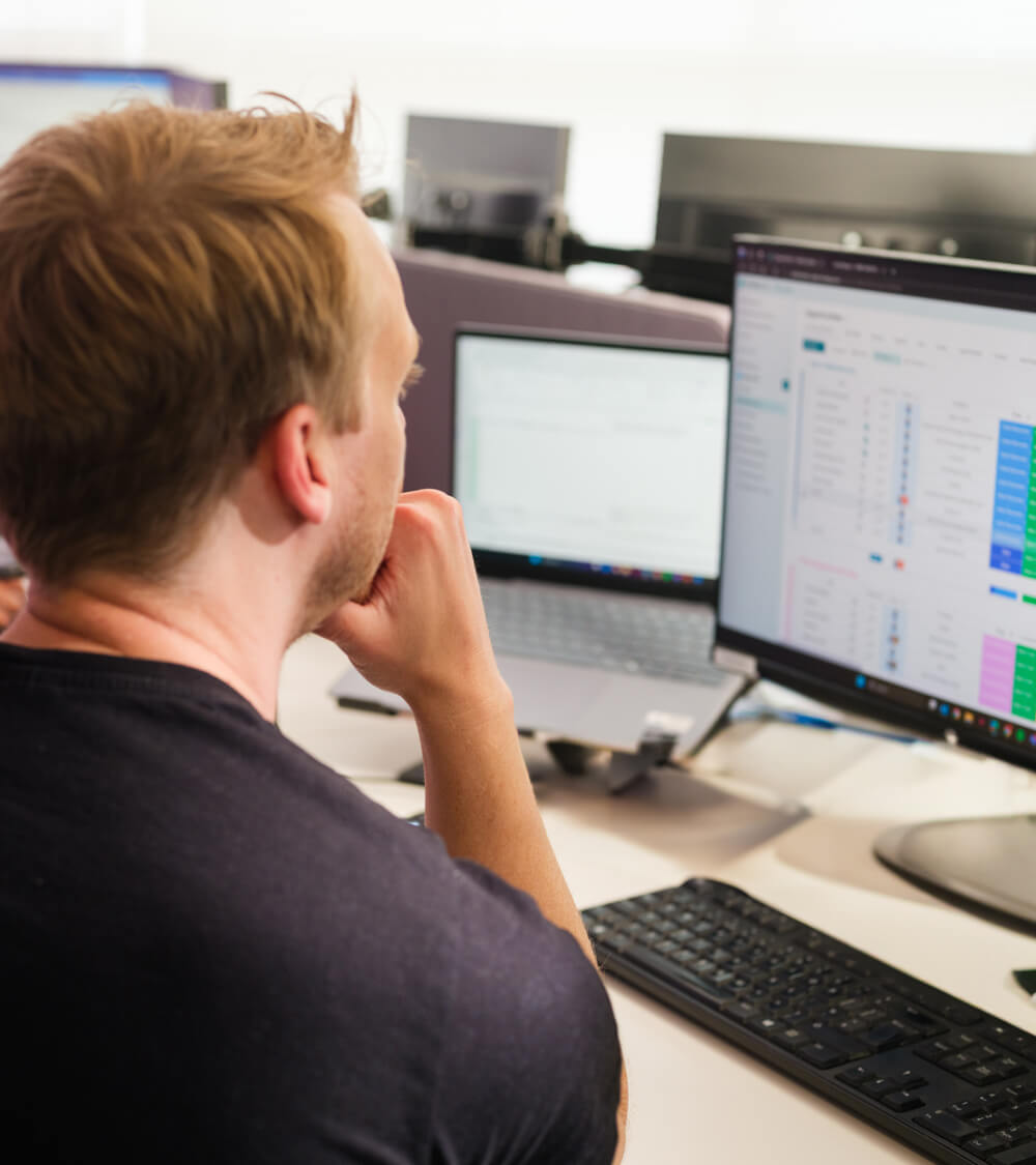 an employee working on their computer in an open plan office space