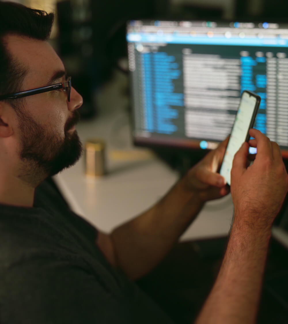 an IT engineer setting-up software on a company mobile phone