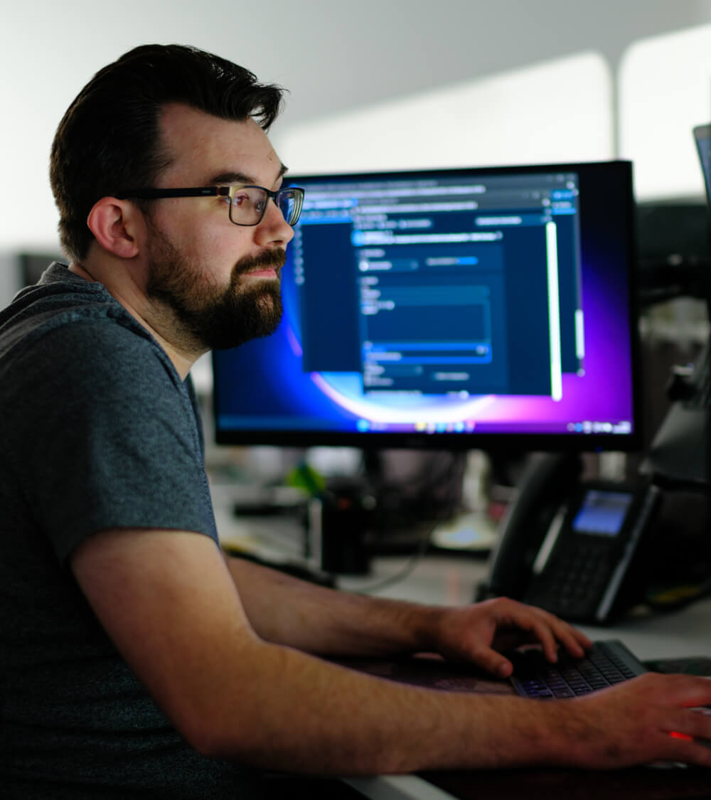 an IT engineer uses their computer to run a security scan