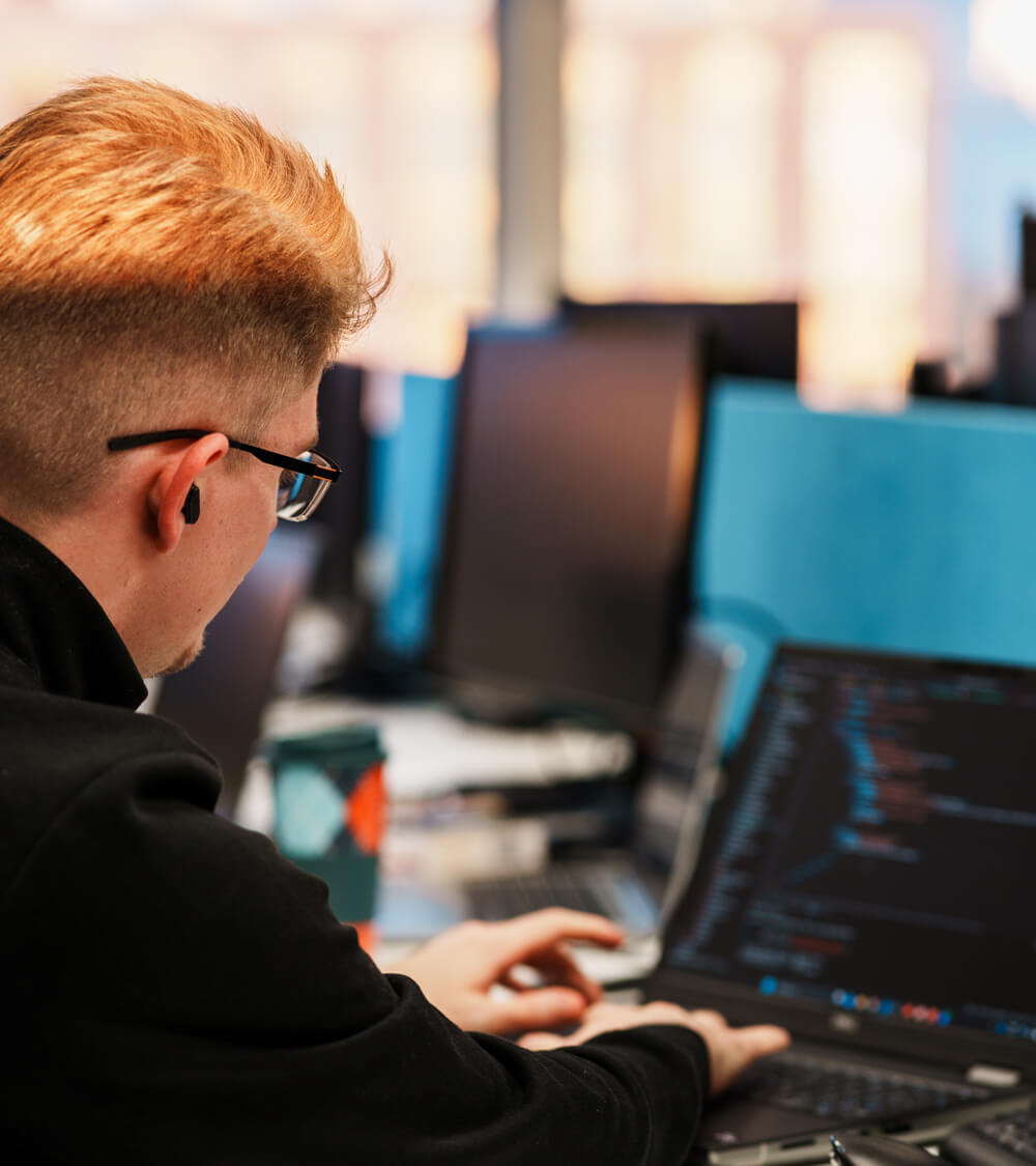 an IT engineer working on their laptop